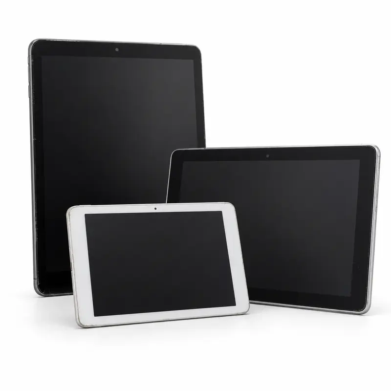 Old tablet computers with blank screens prepared for e-waste pickup evaluation